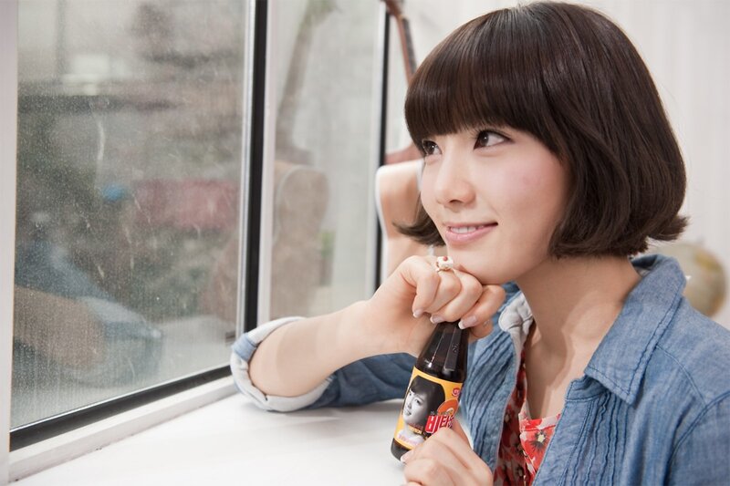 woman holding drink by window