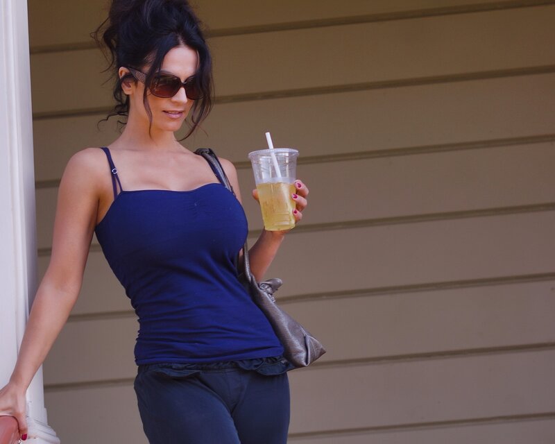 Woman holding drink outside