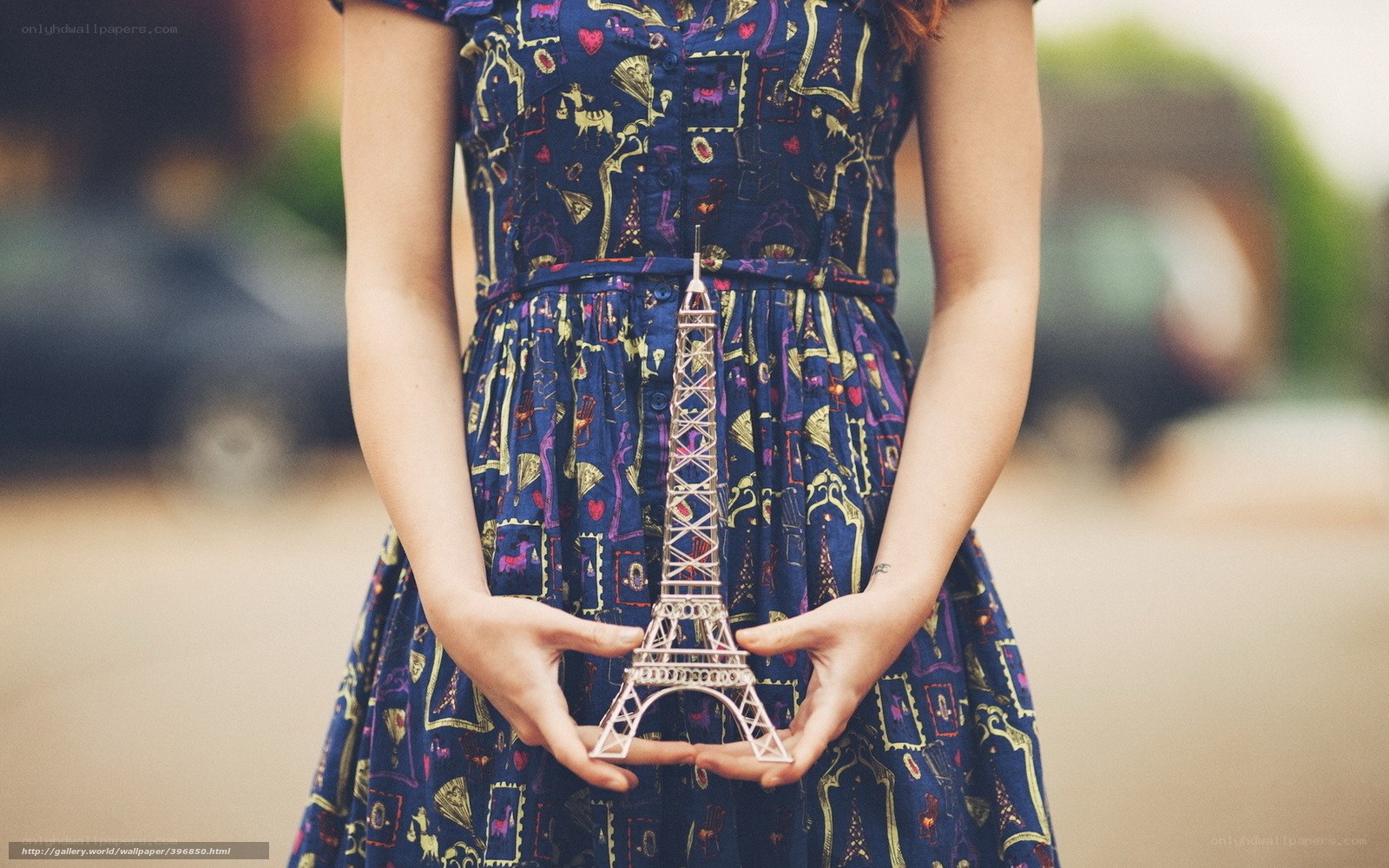 woman holding eiffel tower model
