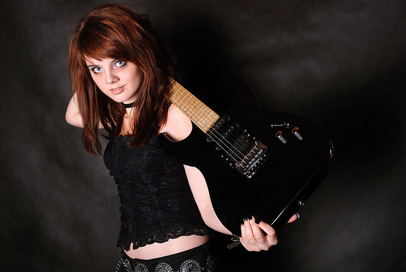 woman holding electric guitar
