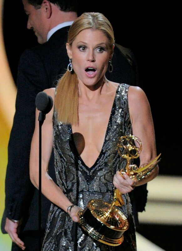 woman holding emmy award