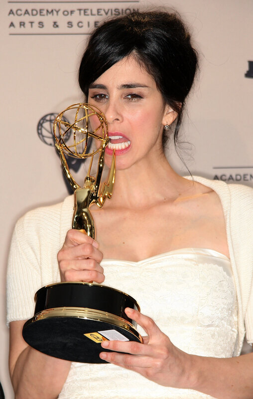 woman holding emmy award