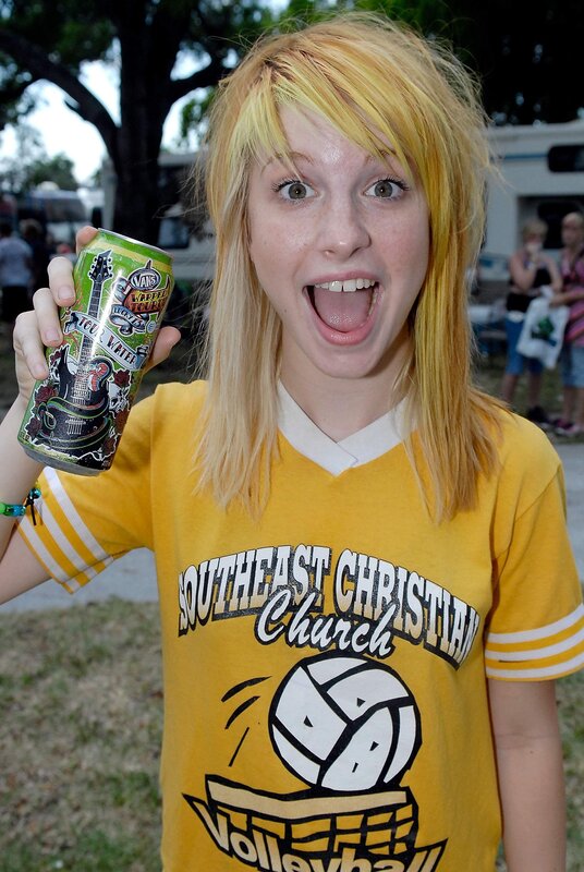 woman holding energy drink can
