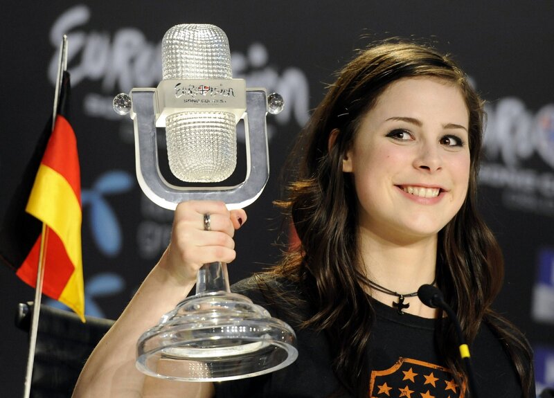 woman holding eurovision trophy