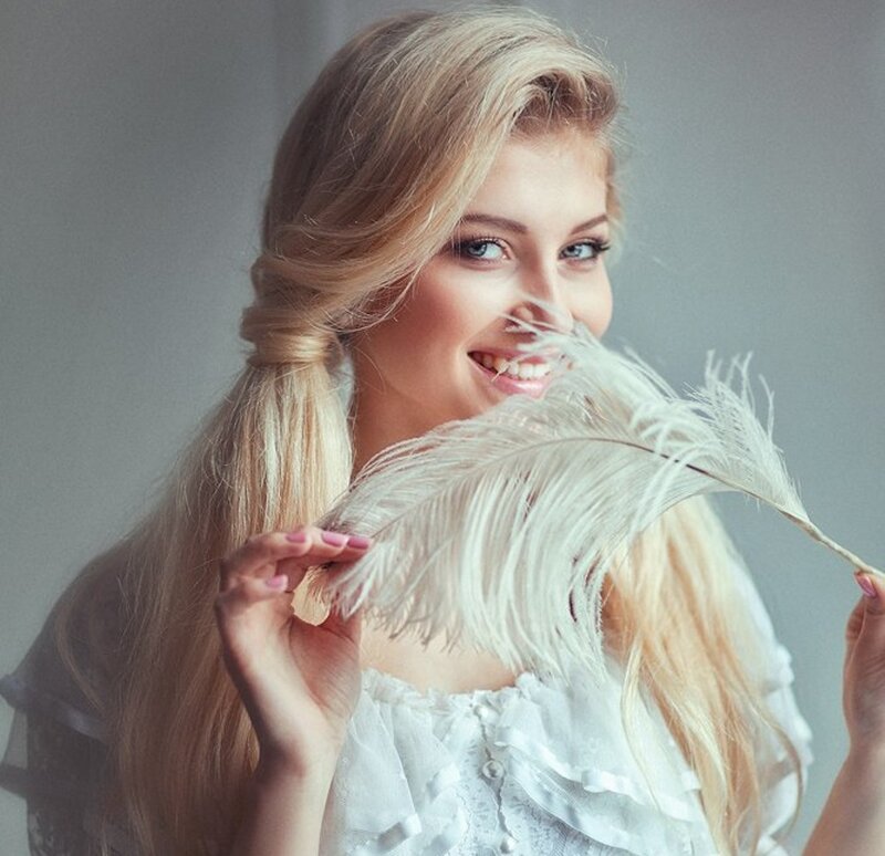 Woman Holding Feather — White, Playful