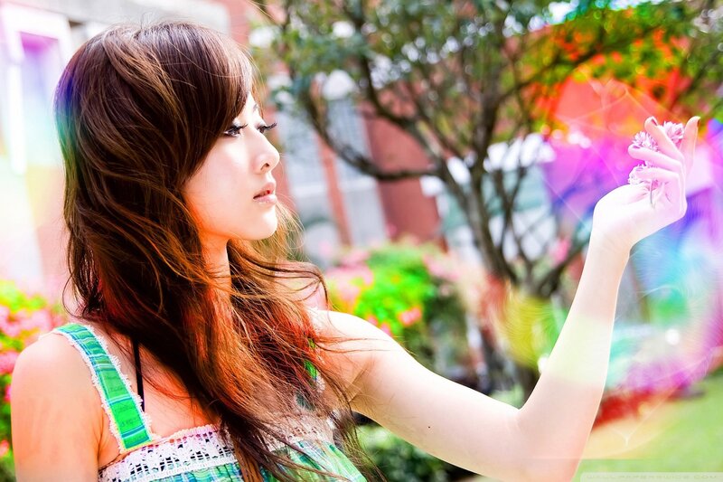 woman holding flower in garden
