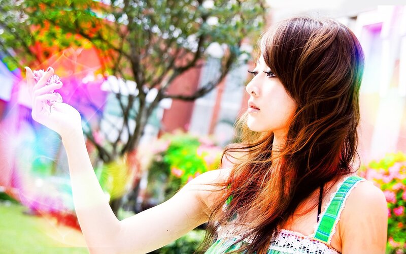 woman holding flower in garden