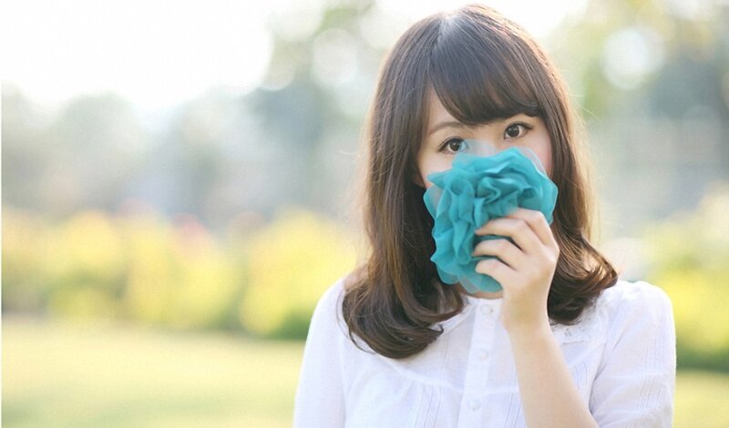 woman holding flower in park