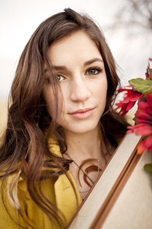 woman holding flowers and book