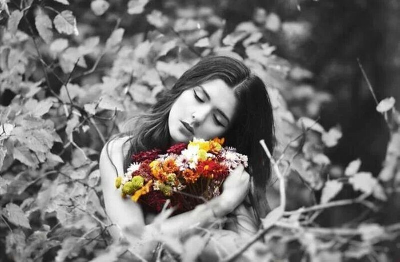 Woman Holding Flowers — Black, Serene, Autumn