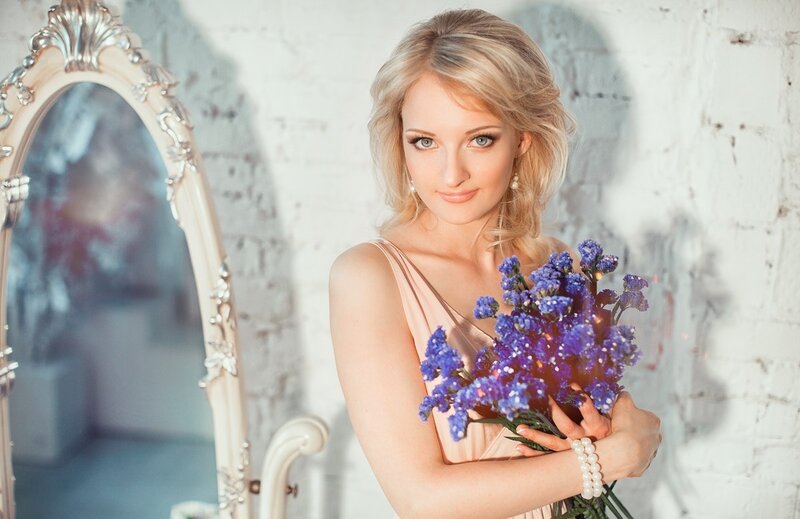 Woman Holding Flowers — Blue, Serene, Afternoon, Photograph