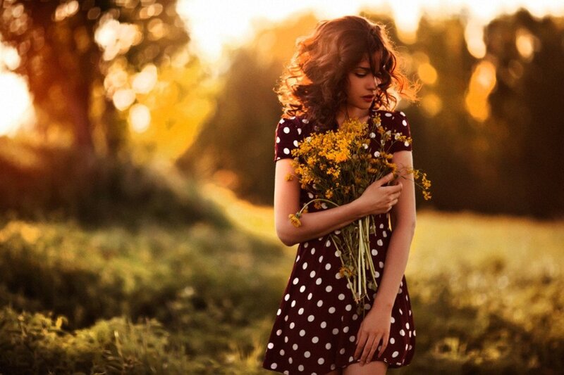 Woman Holding Flowers — Brown, Serene, Sunset