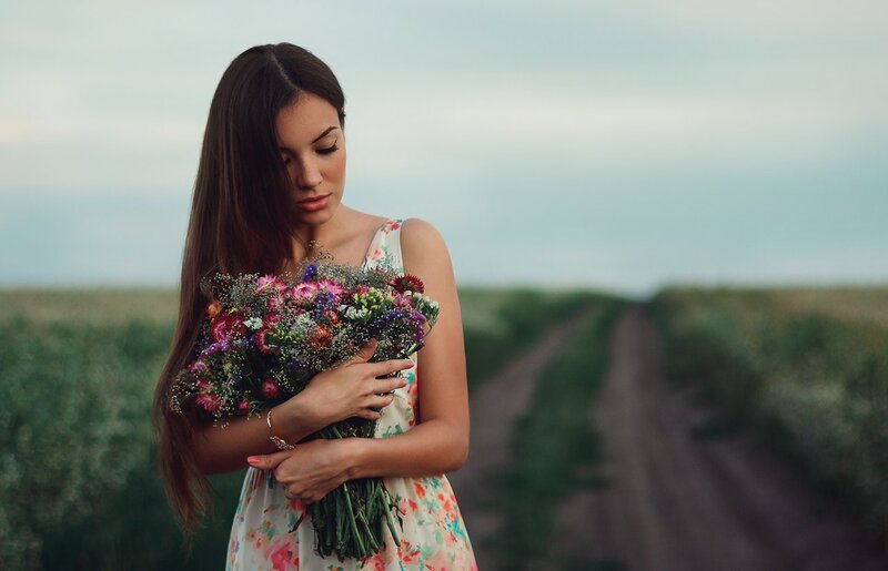 Woman Holding Flowers — Green, Serene, Sunset, Photograph