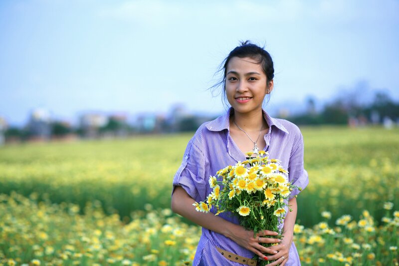 Woman holding flowers in a field