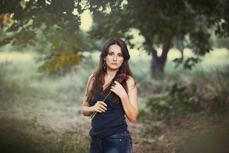 woman holding flowers in a field