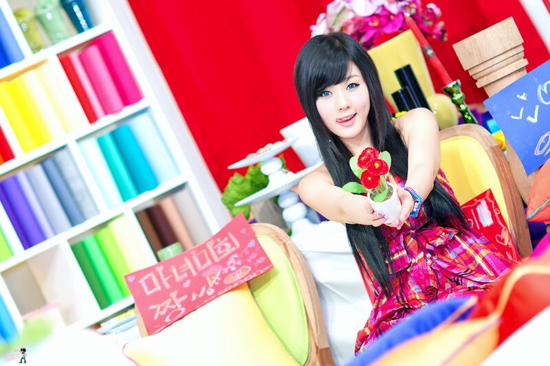 woman holding flowers in colorful room