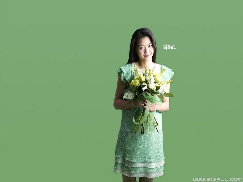 woman holding flowers in green dress