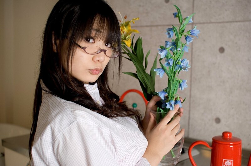 woman holding flowers in kitchen