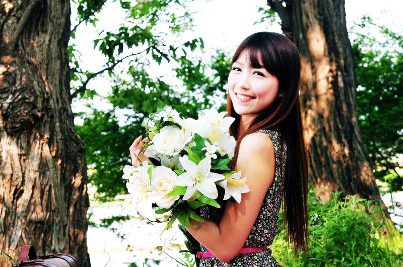 Woman holding flowers in park