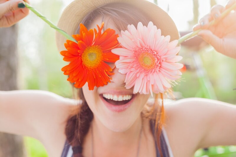 Woman Holding Flowers — Orange, Playful