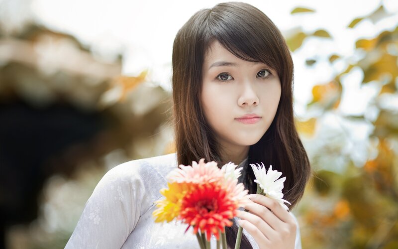 woman holding flowers outdoors