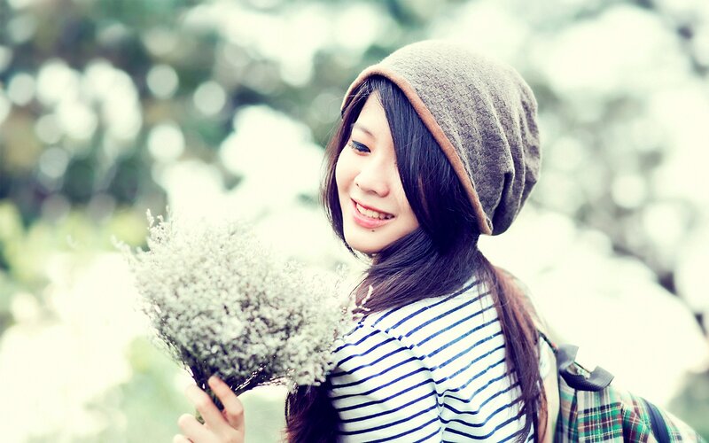 woman holding flowers outdoors