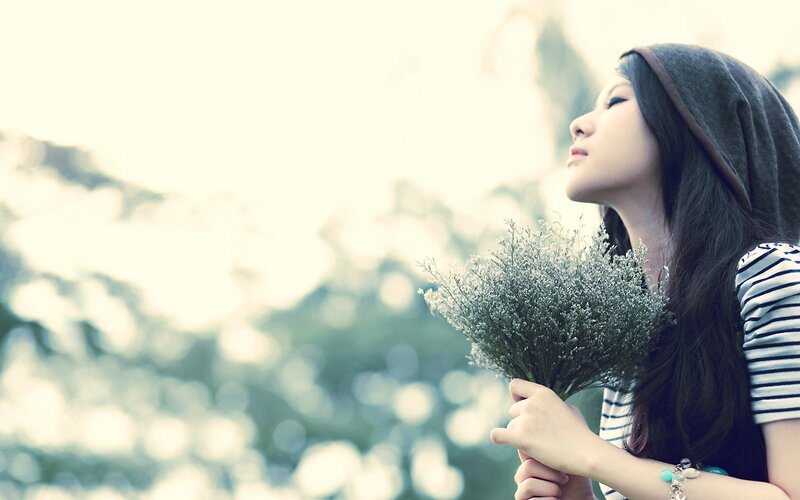 woman holding flowers outdoors