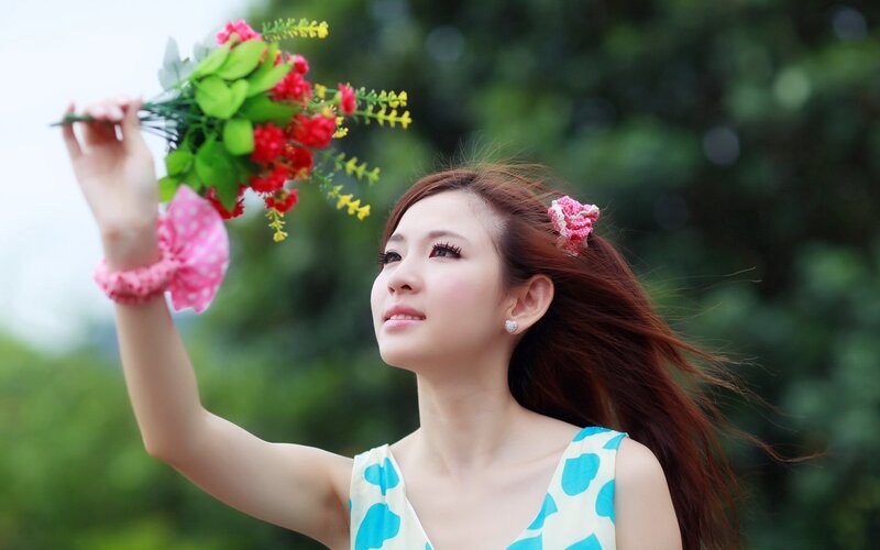 woman holding flowers outdoors