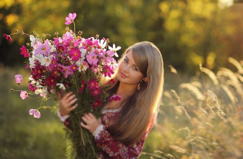 Woman Holding Flowers — Pink, Serene, Sunset, Photograph