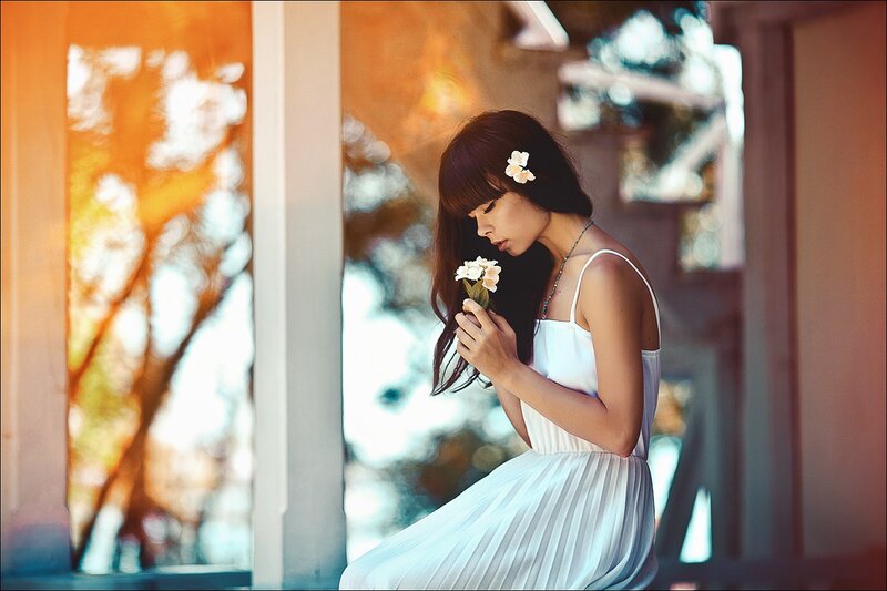 Woman Holding Flowers — White, Serene, Sunset, Photograph