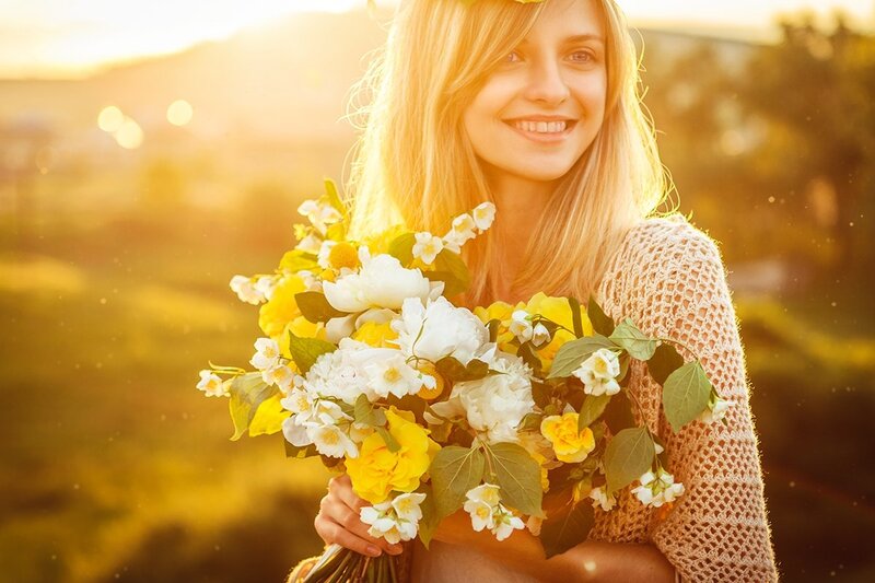 Woman Holding Flowers — Yellow, Serene, Sunset, Photograph, Sunlight