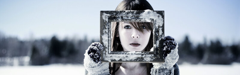 woman holding frame in snow