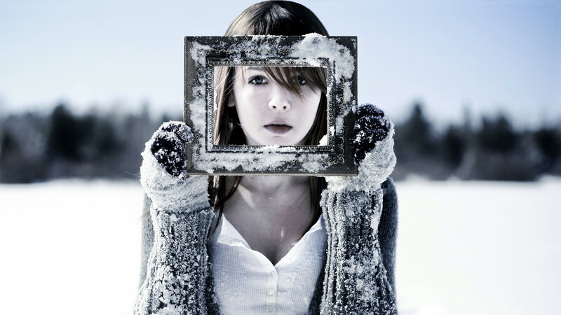 woman holding frame in snow
