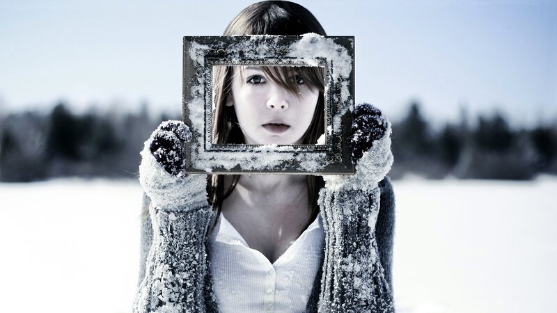 woman holding frame in snow