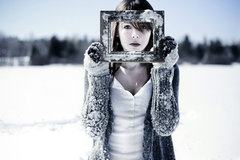 woman holding frame in snow