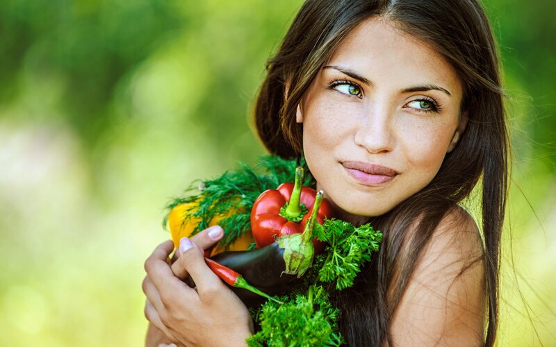 woman holding fresh vegetables