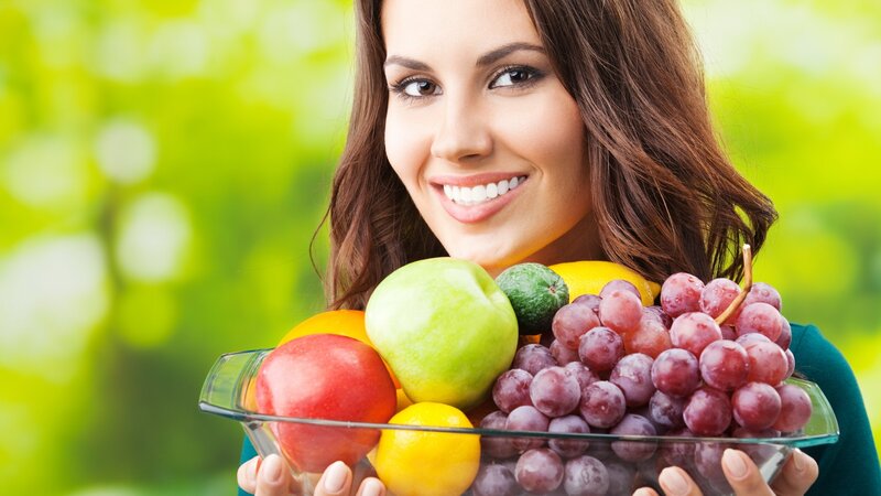 woman holding fruit bowl