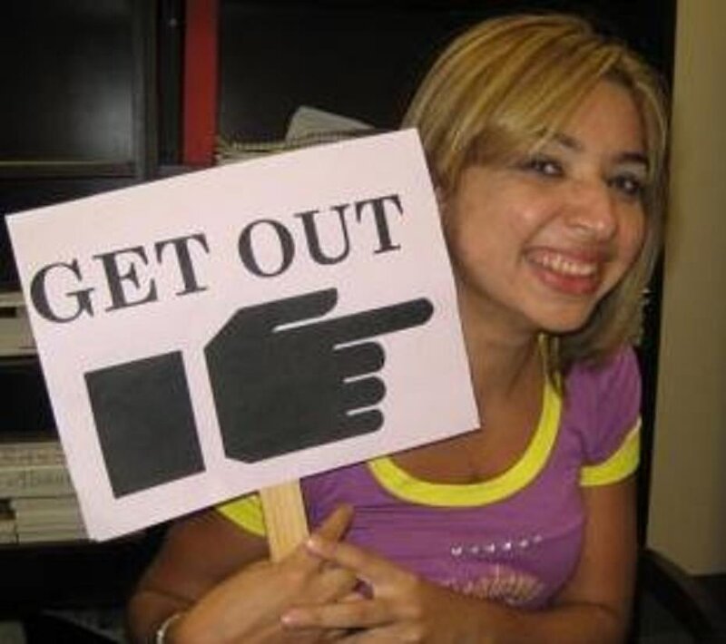 woman holding get out sign