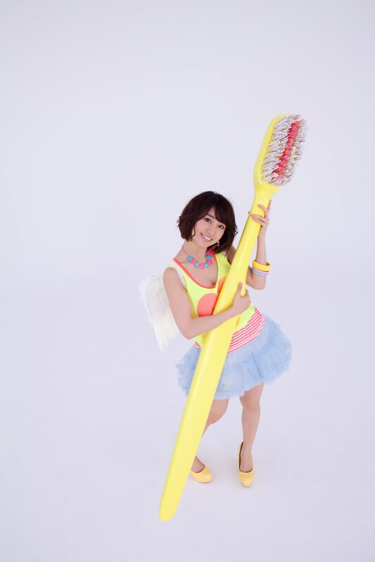 Woman holding giant toothbrush