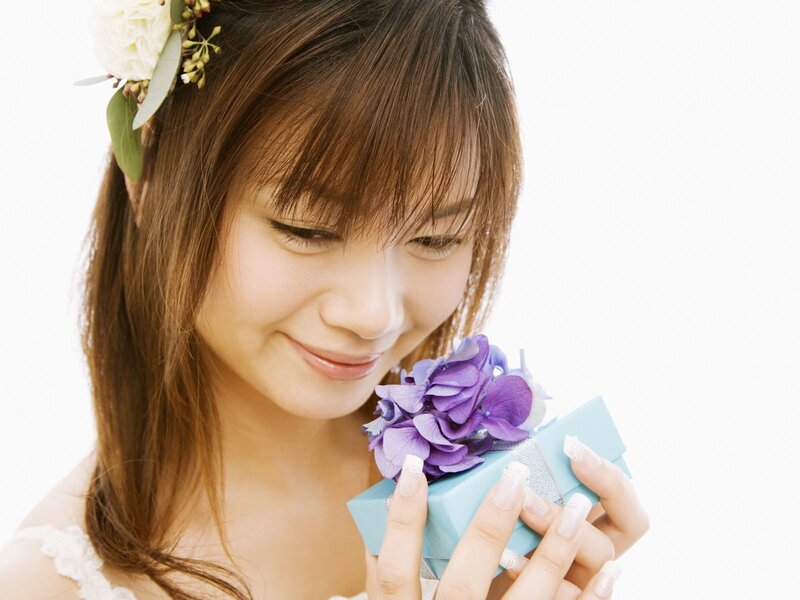 woman holding gift with flowers