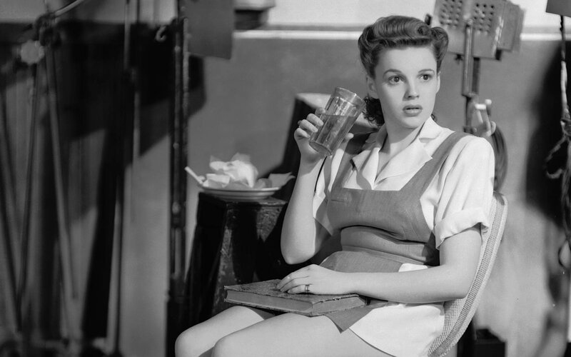 woman holding glass in studio