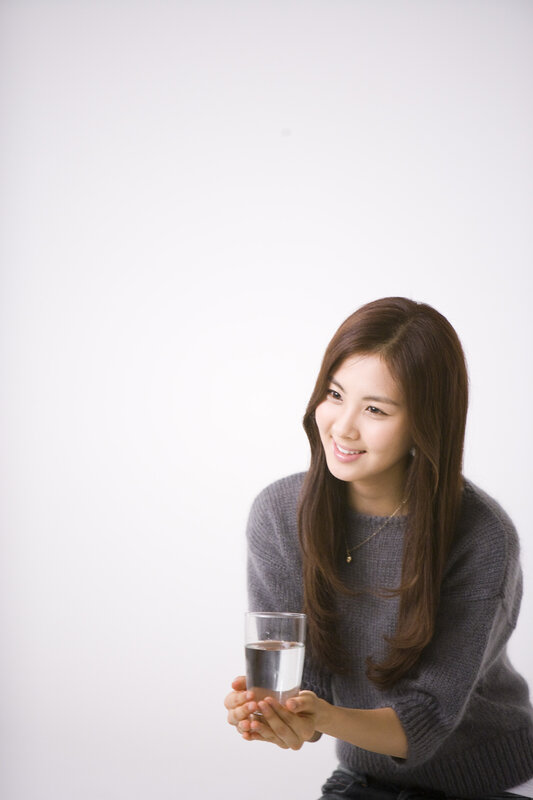 Woman Holding Glass of Water — Gray
