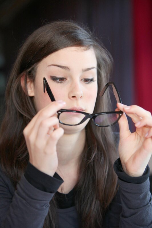 woman holding glasses