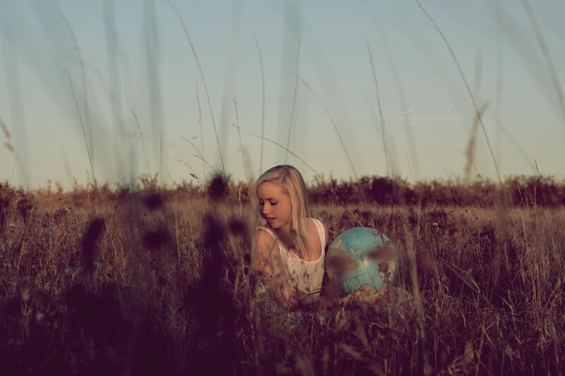 woman holding globe in field