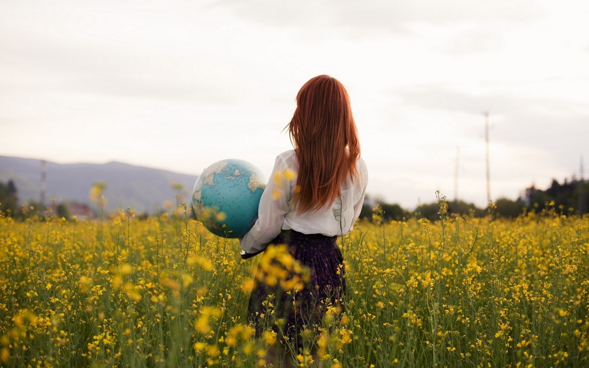 woman holding globe in field