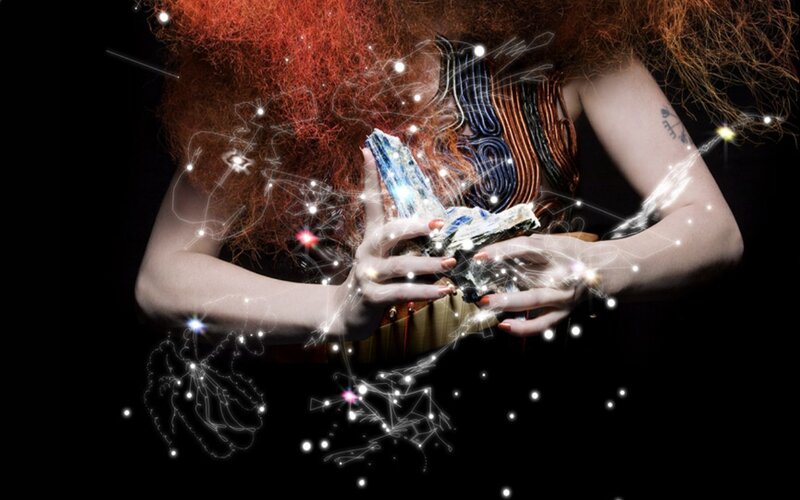 woman holding glowing crystal
