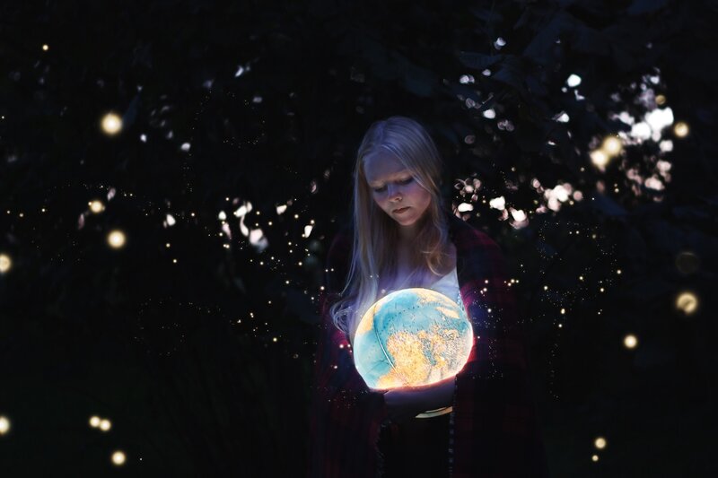 Woman Holding Glowing Globe