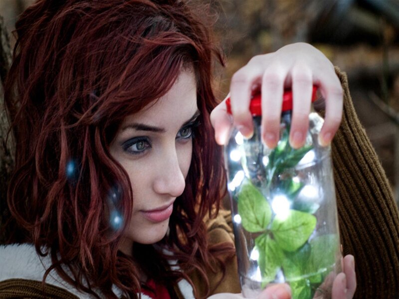 woman holding glowing jar
