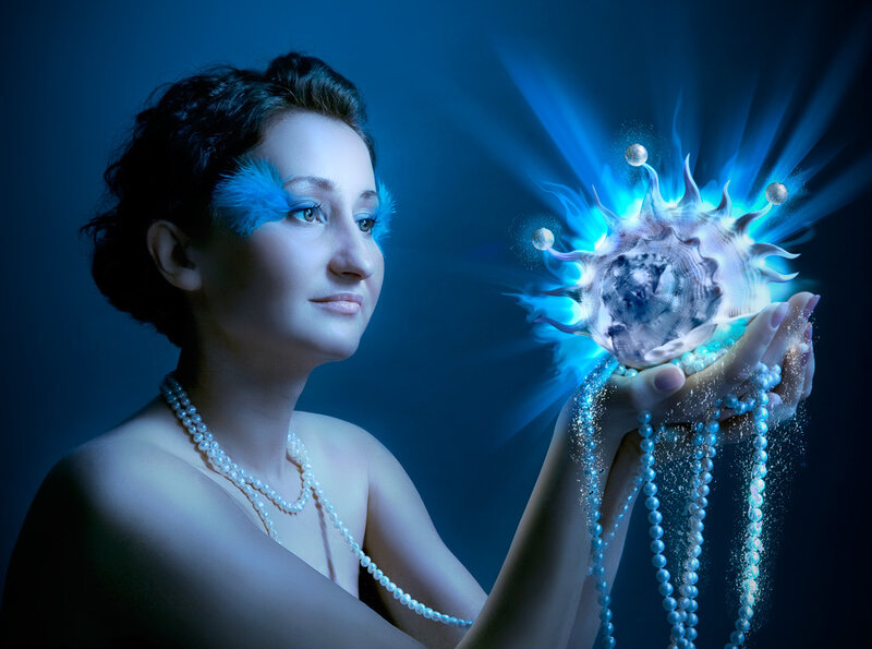 Woman Holding Glowing Shell — Blue