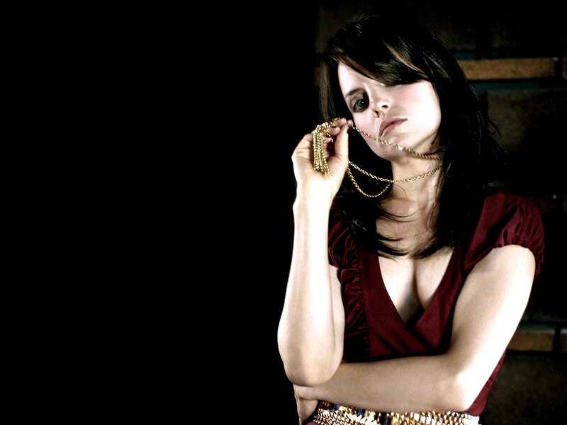 woman holding gold necklace